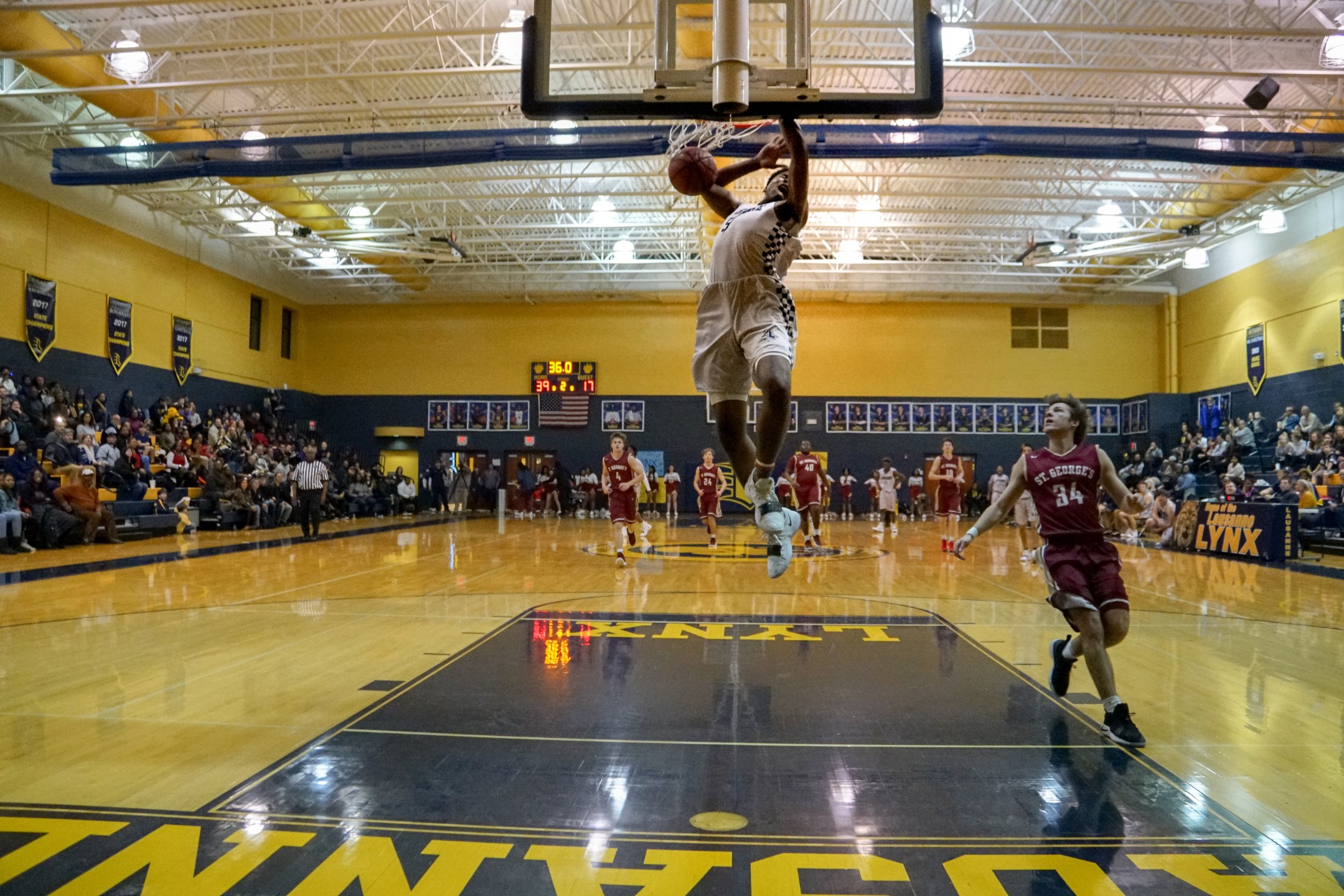 Basketball player dunking ball during game