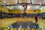 Basketball player dunking ball during game