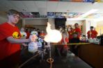 Student doing a science experiment that results in a flame