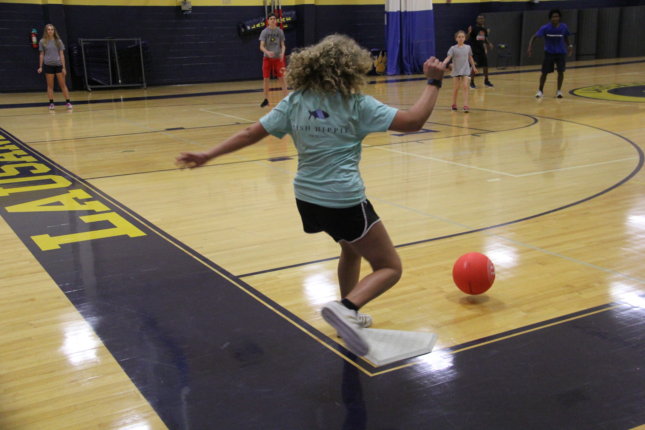 Student kicking ball in kickball game