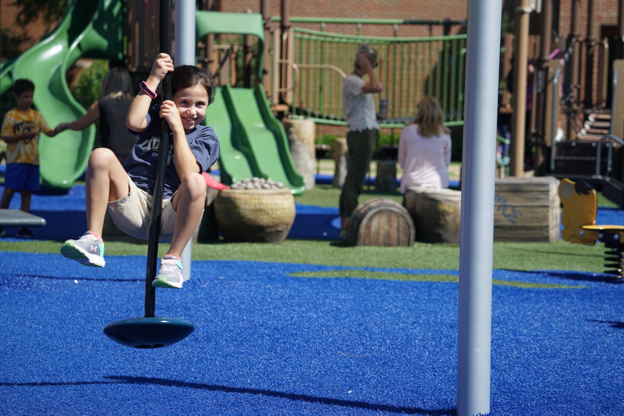 Student swinging on playground
