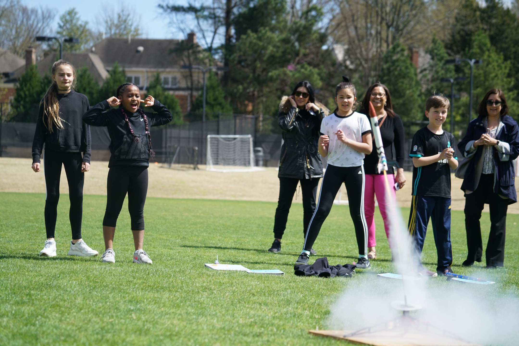 Group of students watching a rocket take-off