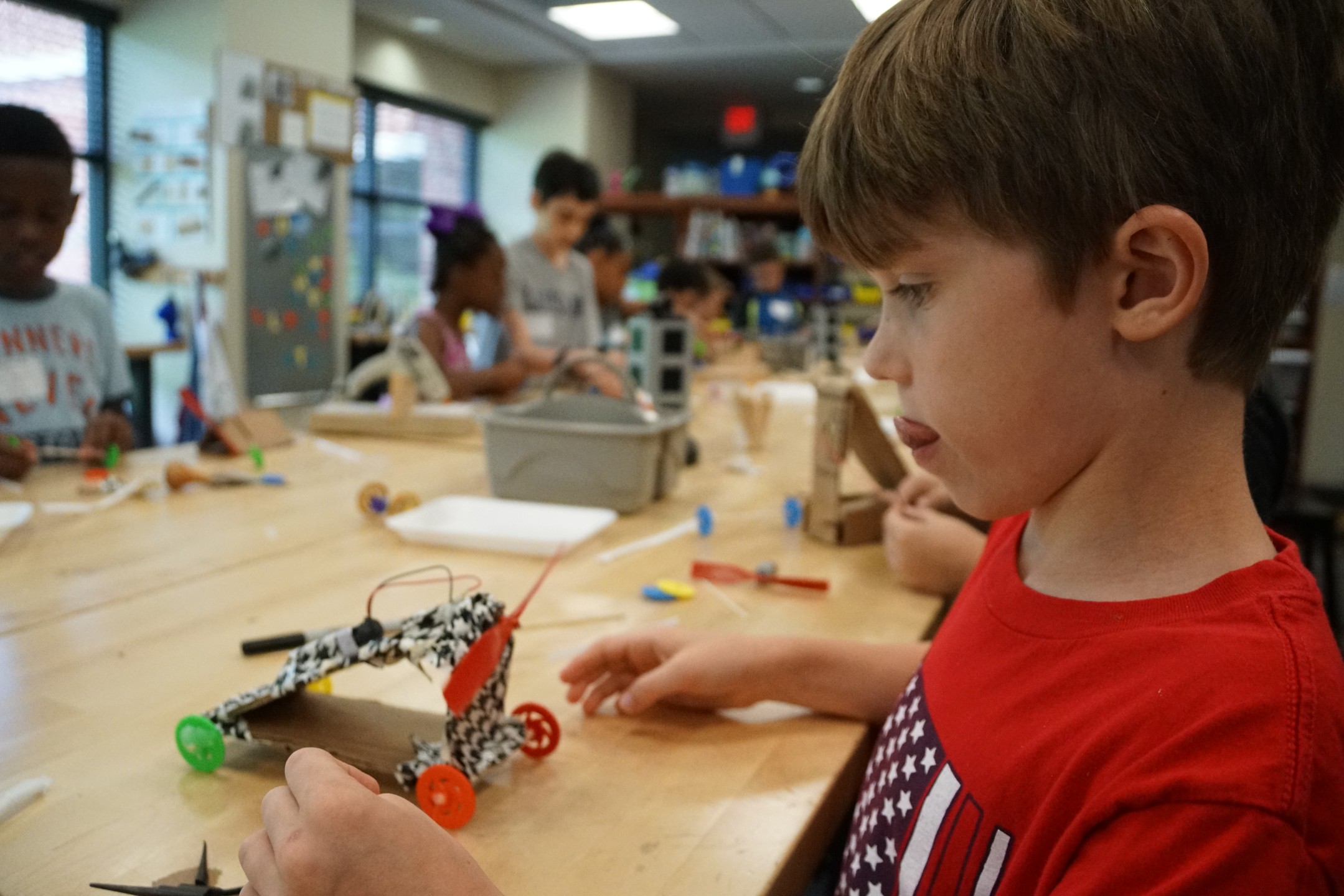 Boy in red shirt working in makerspace