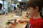 Boy in red shirt working in makerspace