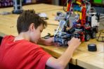 Boy working on robot